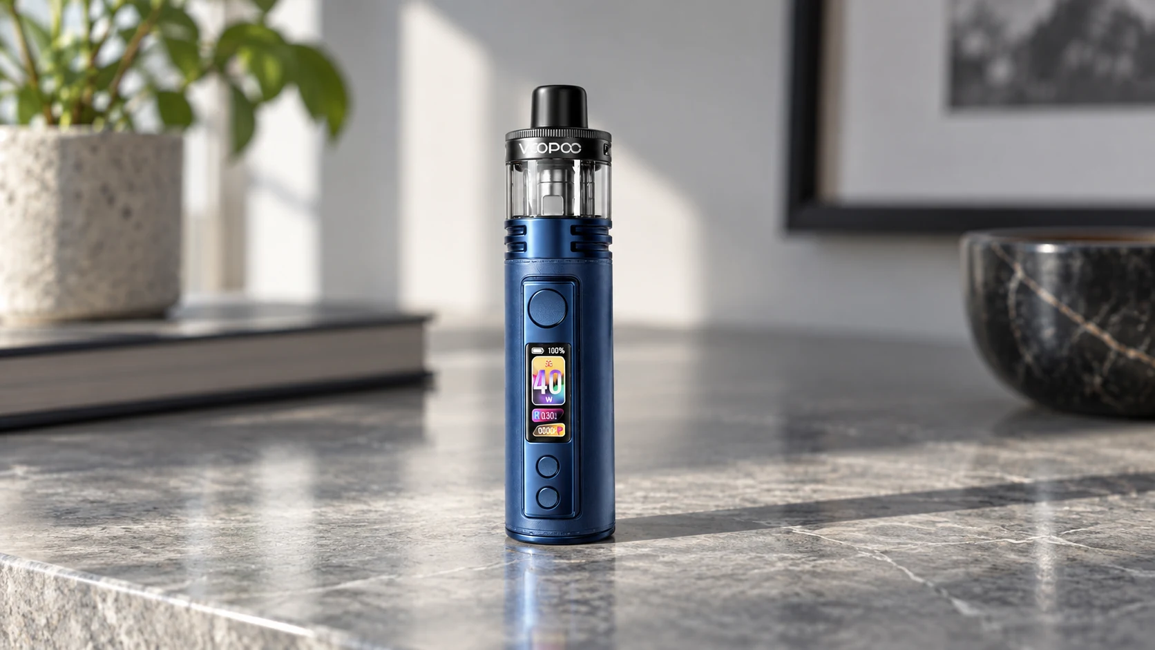 Blue VOOPOO DRAG H40 Pro pod mod standing upright on a polished stone countertop in soft daylight.